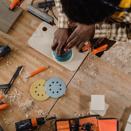 Ponçage d’un plateau de bois à l’atelier